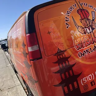 Van in back of food truck
