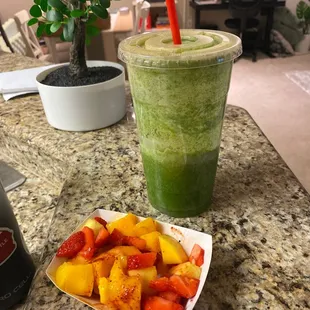 a bowl of fruit and a drink