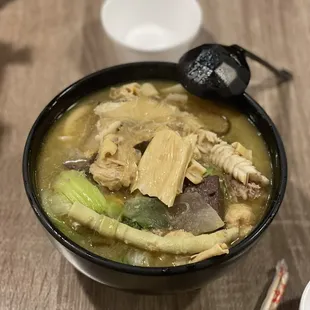 a bowl of soup and chopsticks