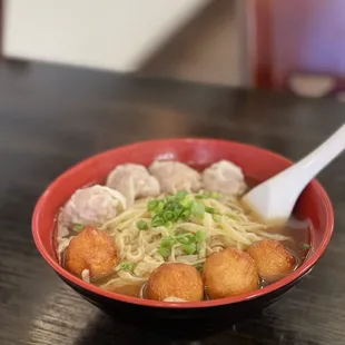 a bowl of noodles and meatballs