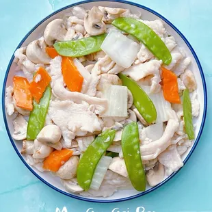 a plate of chicken and snow peas