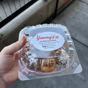 a hand holding a plastic container