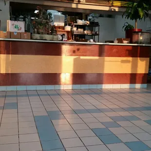 a restaurant counter and tiled floor