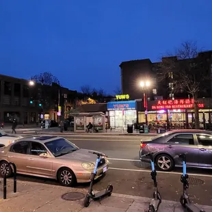 two scooters parked on the sidewalk