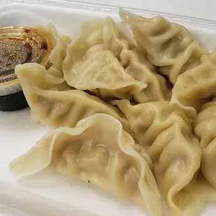 Steamed dumplings with black vinegar sauce for dipping.