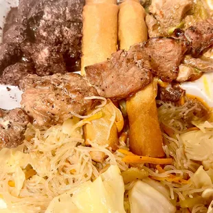 Pinoy Feast with Pancit, BBQ Pork Stick, Pork Lumpia, Dinuguan, and Pork and Peas