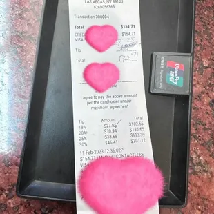 a receipt with a pink heart on it