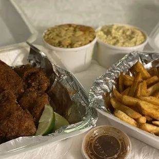 a tray of fried chicken and french fries