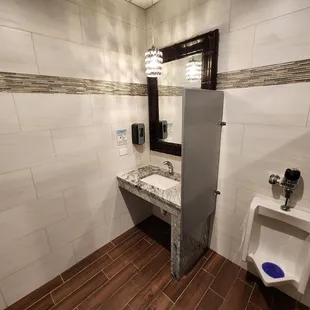 a bathroom with a urinal and sink