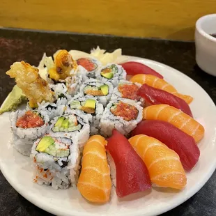 a plate of sushi and rolls