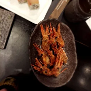 a plate of shrimp and sushi