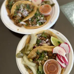 two plates of tacos on a table