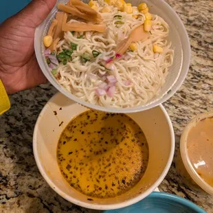 Toppings on the top, broth on the bottom.