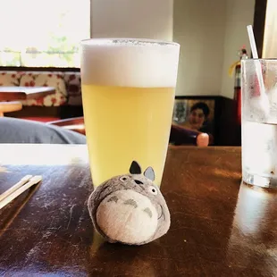 a glass of beer and a stuffed animal