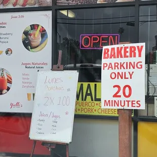 a sign in front of a bakery