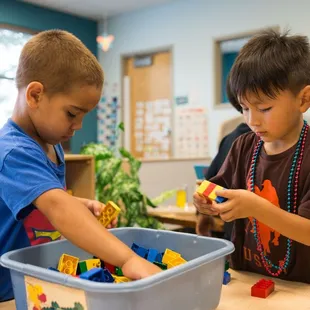 Boys playing with Lego blocks.