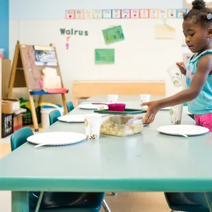 Girl helping get ready for lunch.