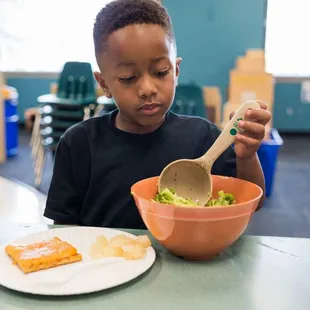 Boy serving and eating a healthy lunch.