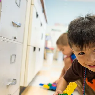 Boy playing with Lego blocks.