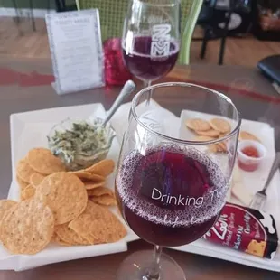 a glass of wine and crackers