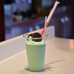 a cup of ice cream and a straw