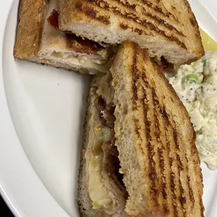 a grilled sandwich and coleslaw on a white plate