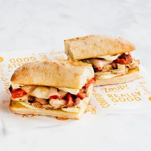 two sub sandwiches on paper