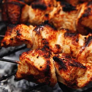 chicken skewers on a grill
