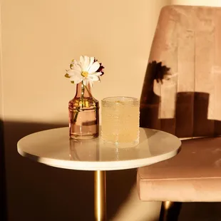 a glass of water and a vase on a table