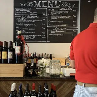 a man standing in front of a menu