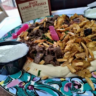 Chicken n Beef Shawarma cut off the Spit on a bed of Hummus OMG Delicious