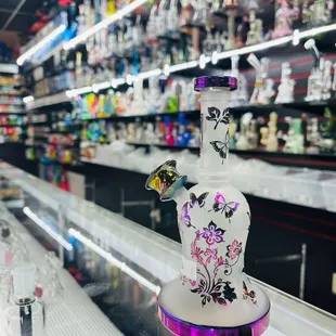 a glass bottle with a colorful design on it