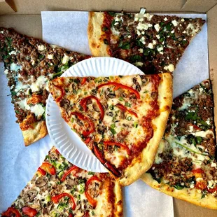 several slices of pizza in a cardboard box