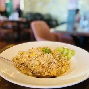 a plate of fried rice with broccoli