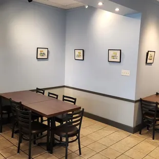 a dining area with tables and chairs