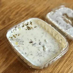 two containers of yogurt on a table