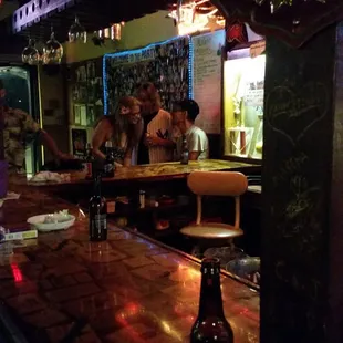 a bar with people sitting at the bar