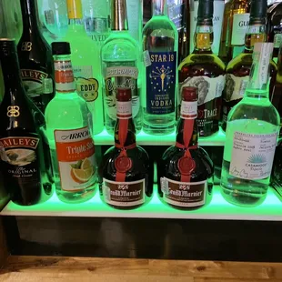 a shelf of liquor bottles