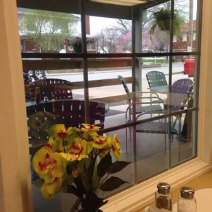 a vase of flowers in front of a window