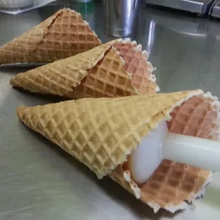 three waffle cones on a table
