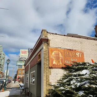 a brick building with a sign on it