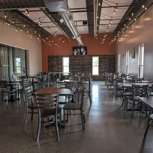 The picnic style bench and barrel seating has been swapped for tables &amp; chairs. (Summer 24&apos;)