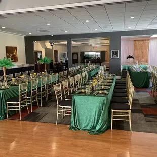 tables and chairs with green tablecloths