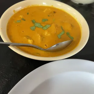 a bowl of soup and a plate of rice