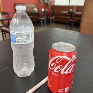 a soda and a pencil on a table