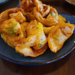 Onion Pakora, Tartly Spiced Fritters Made With Onion And Seasoned Chickpea-Flour Batter And Served With Mint and Tamrind Sauces.