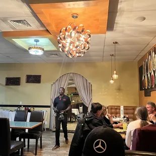 a waiter standing at the front of the restaurant