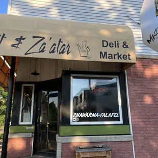 Outside view. There is some outdoor seating available with partial shade