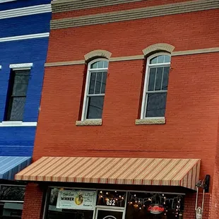 a red brick building with awnings