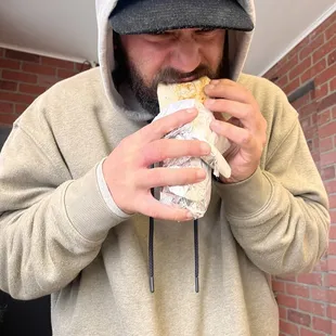 a man eating a sandwich